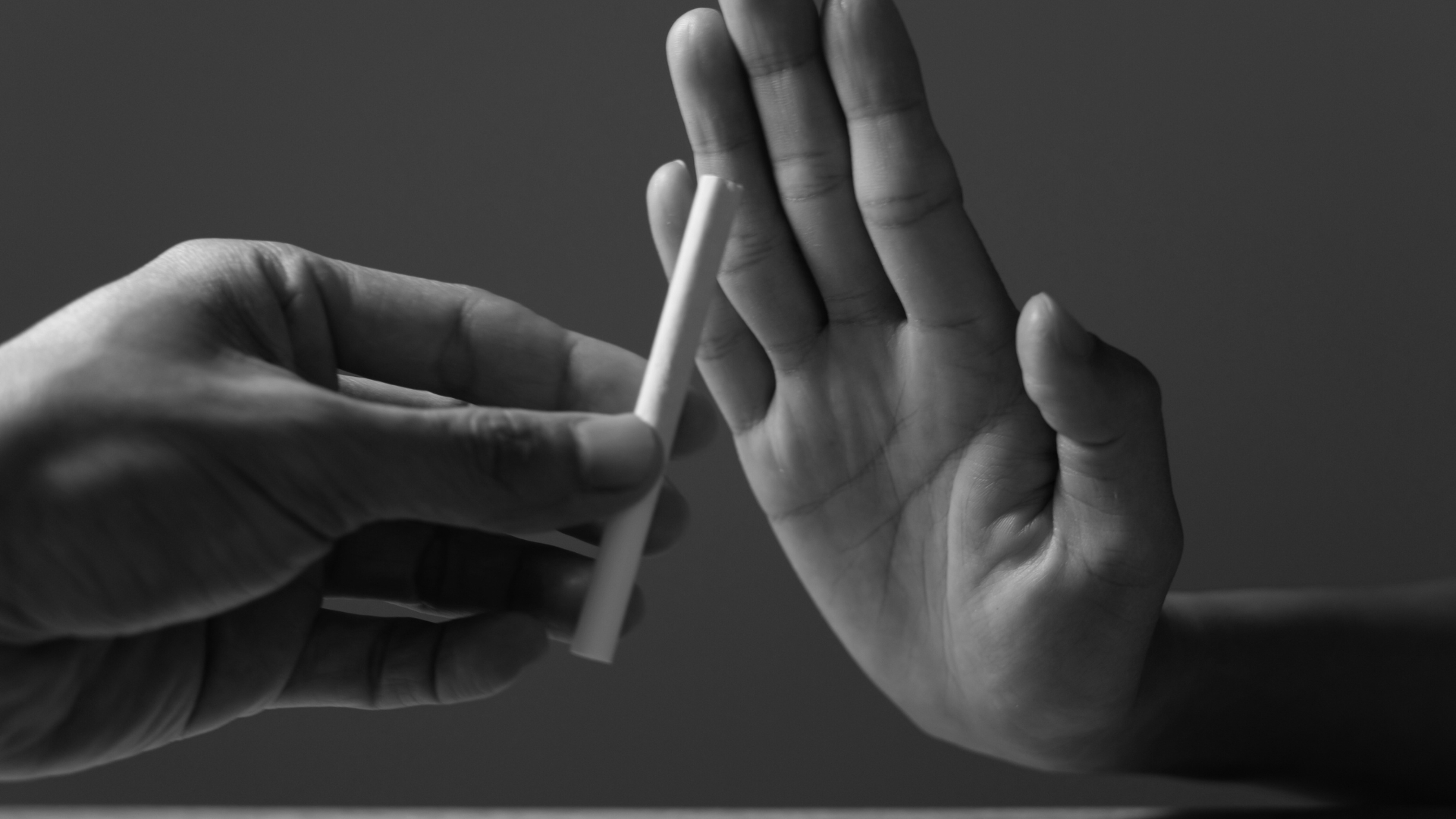 A determined individual rejects a cigarette, symbolizing the decision to quit smoking for better lung health and endurance in fitness.