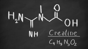 A hand-drawn molecular structure of creatine on a blackboard, illustrating its composition and scientific background.