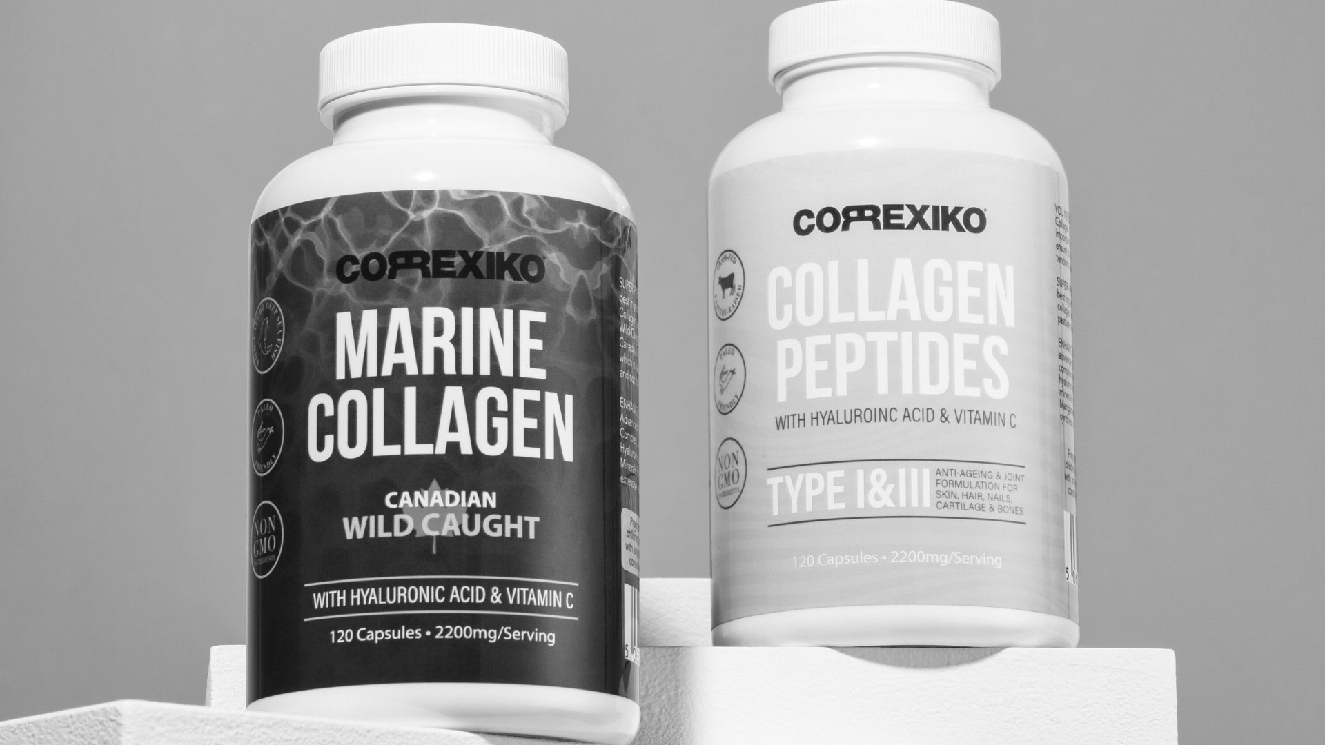 Two bottles of collagen peptides and marine collagen supplements on a white display platform, showcasing their branding and ingredients.