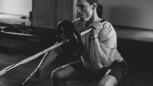 Athlete performing a barbell LANDMINE to build UPPER-body strength and balance.