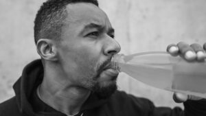 Fighter staying hydrated during intense training at the gym.