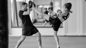 Fighter visualizing techniques during a focused mental rehearsal session in the gym.