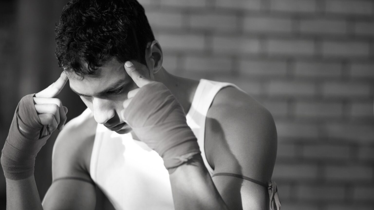 Fighter visualizing fight strategies to boost mental toughness and confidence in a gym setting