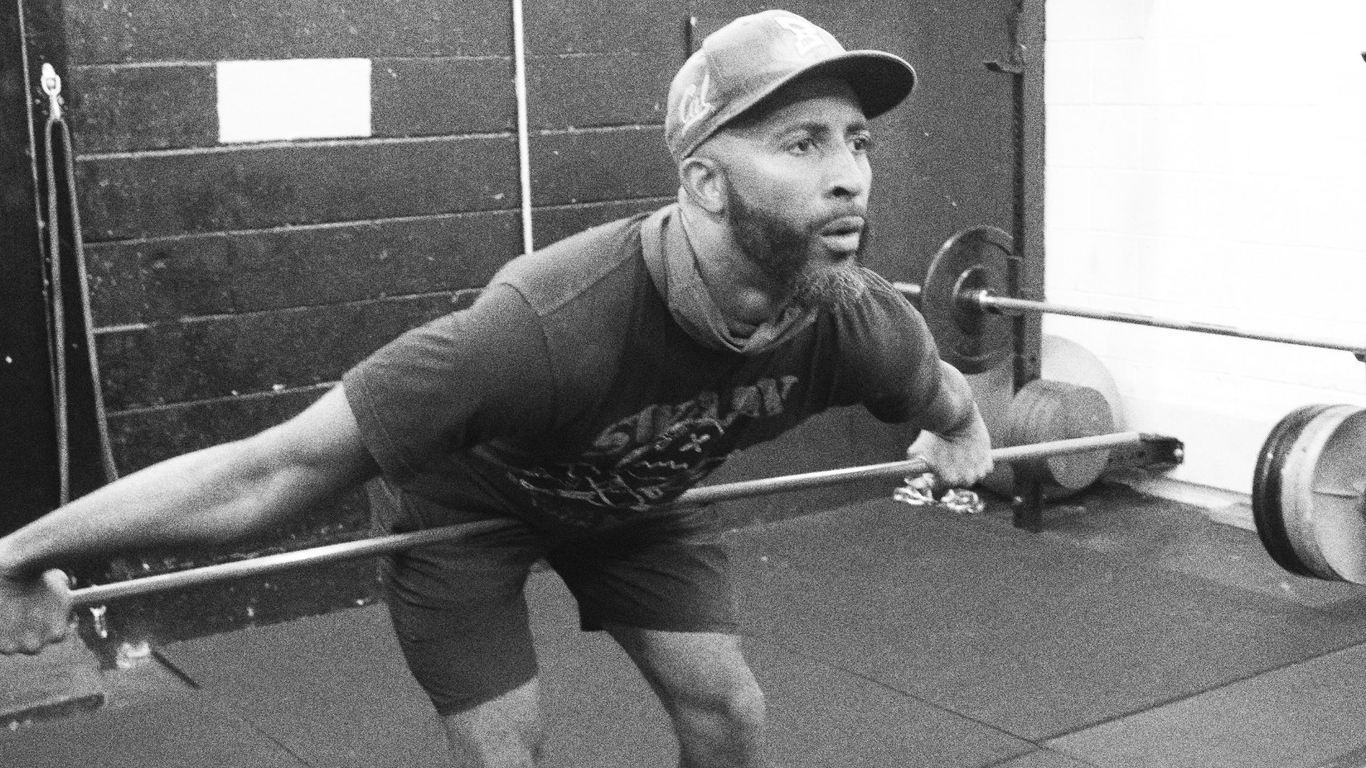 Johann Francis focusing on barbell mobility drills, refining movement and stability for strength and performance. The foundation of elite athletic conditioning.