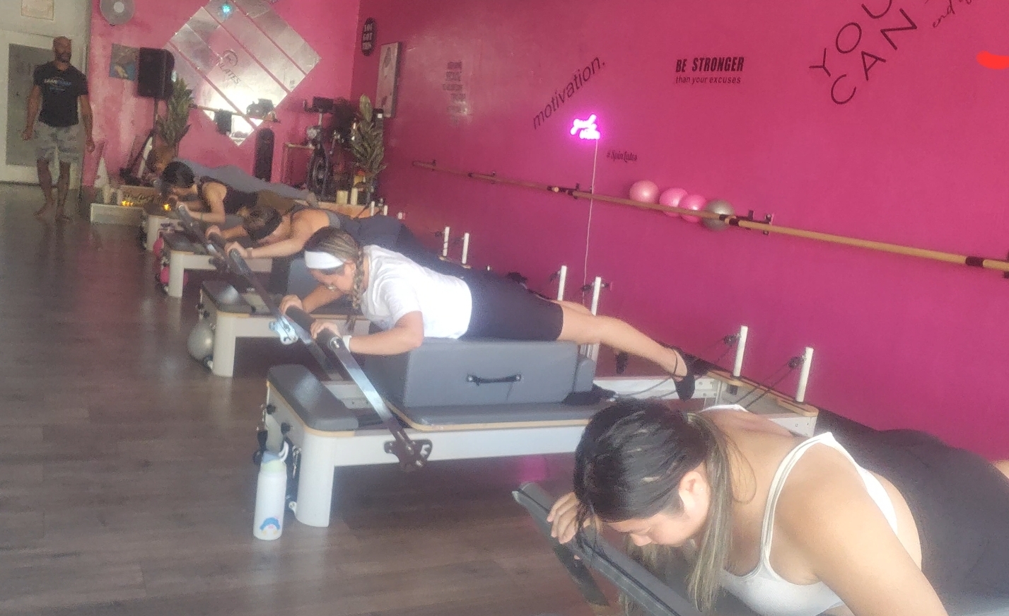 Pilates Reformer class in session at Pacific Spin & Strength in San Jose, with participants focusing on core strength, stability, and controlled movement under expert guidance.