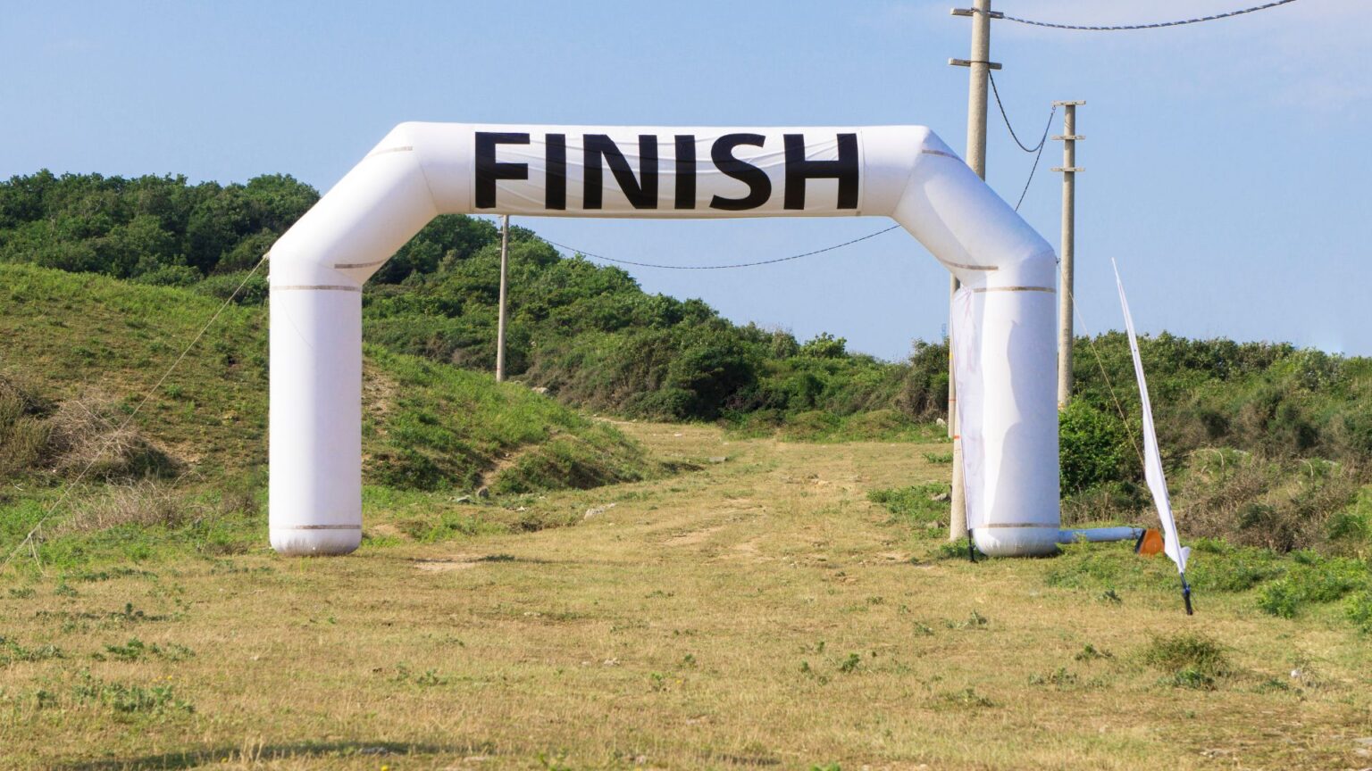 Inflatable finish line arch on a scenic trail, marking the goal for dedicated runners.