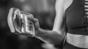 woman using digital grip dynamometer for grip strength test and assessment