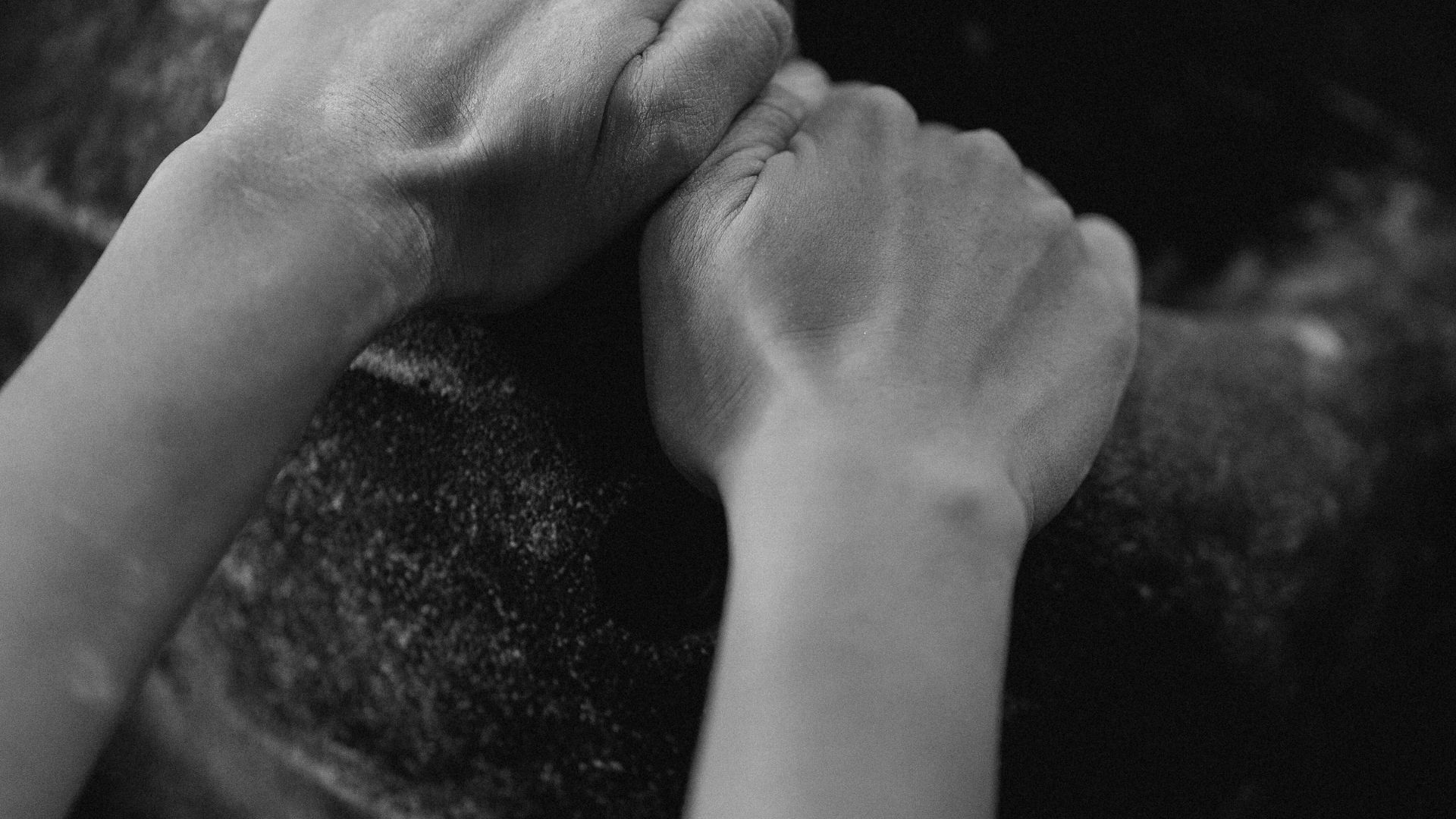 close-up of hands performing plate pinch for pinch grip strength exercise